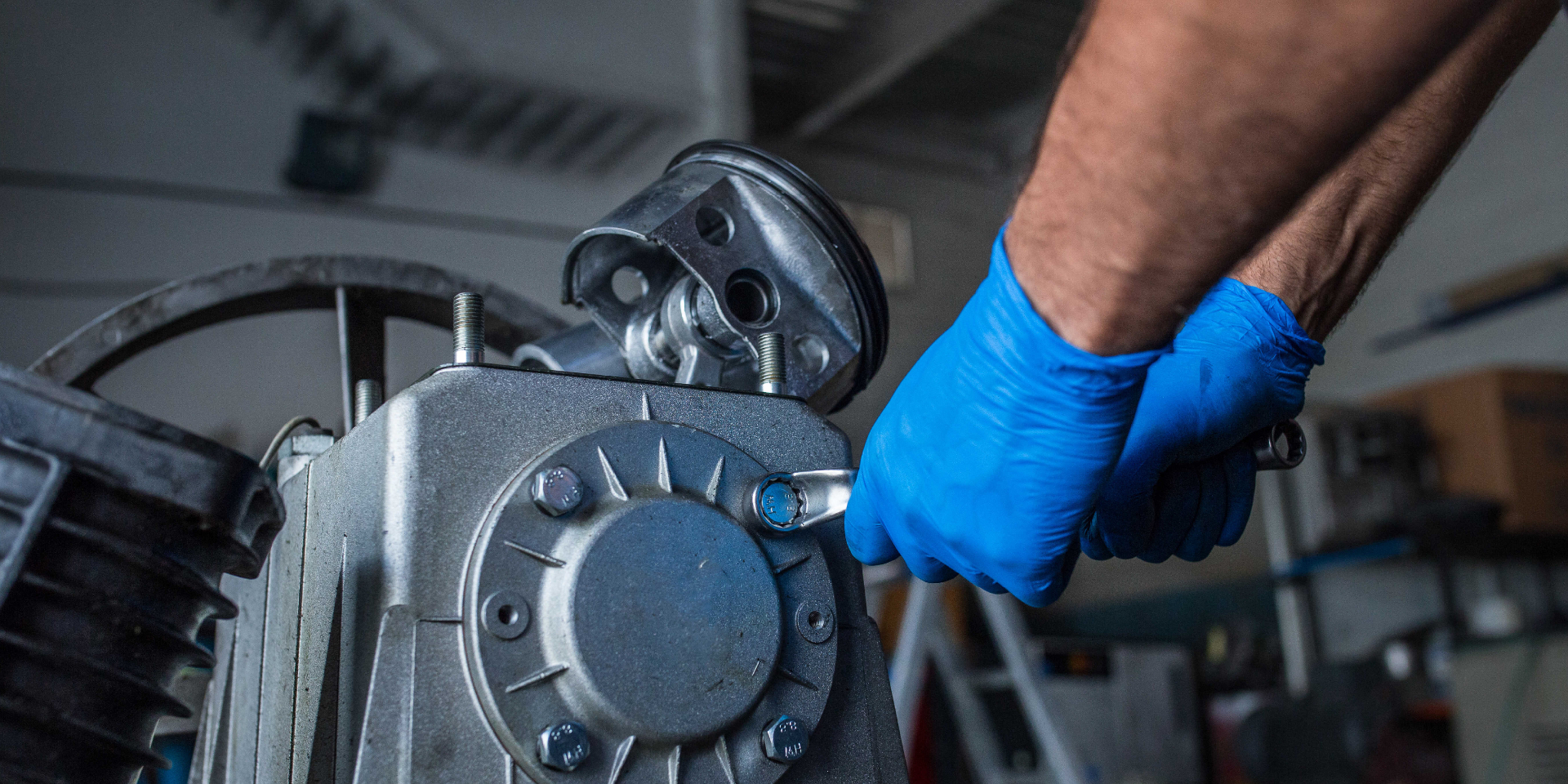 A technician servicing HVAC compressor components
